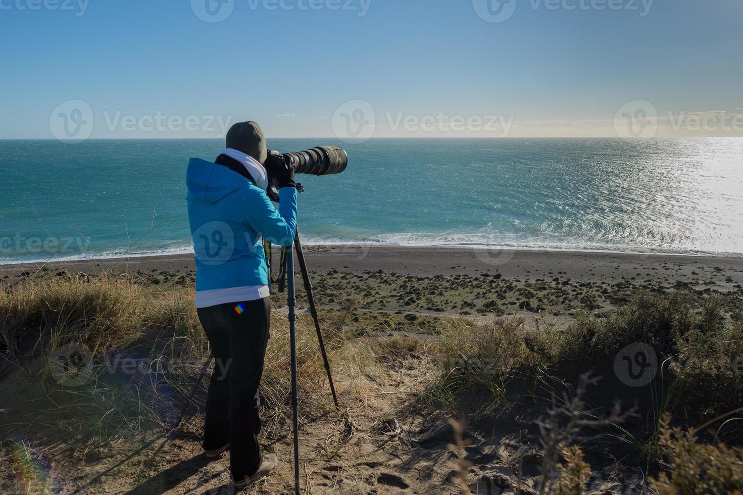 girl photographing landscape in patagonia photo