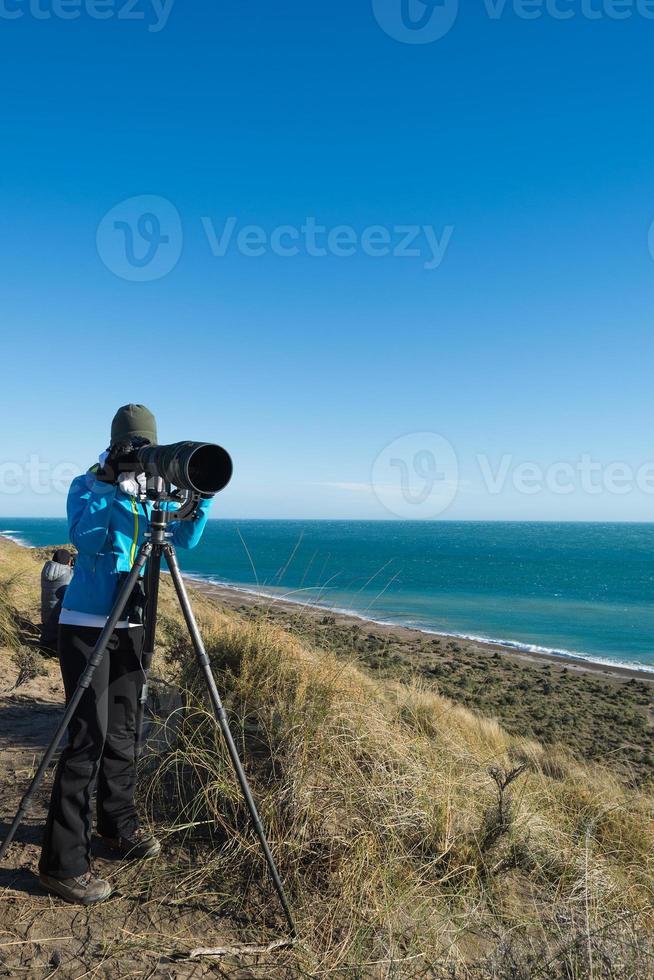 girl photographing landscape in patagonia photo