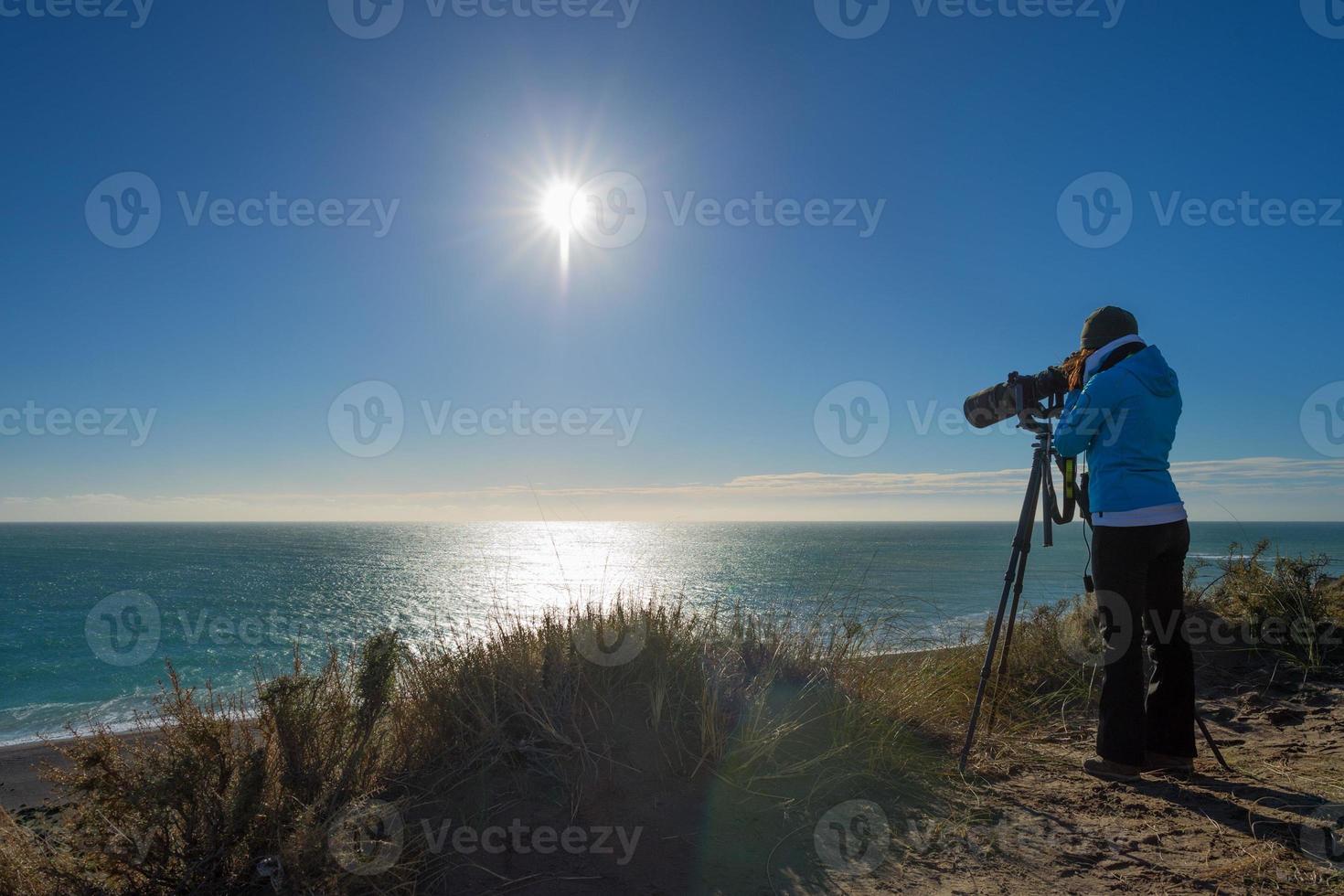 girl photographing landscape in patagonia photo