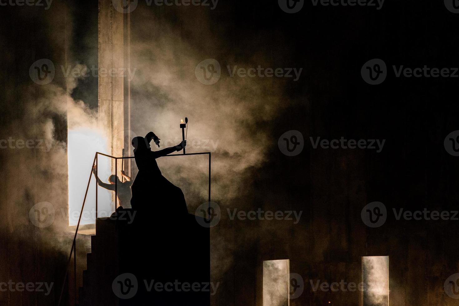 wizard magician silhouette holding a torch photo