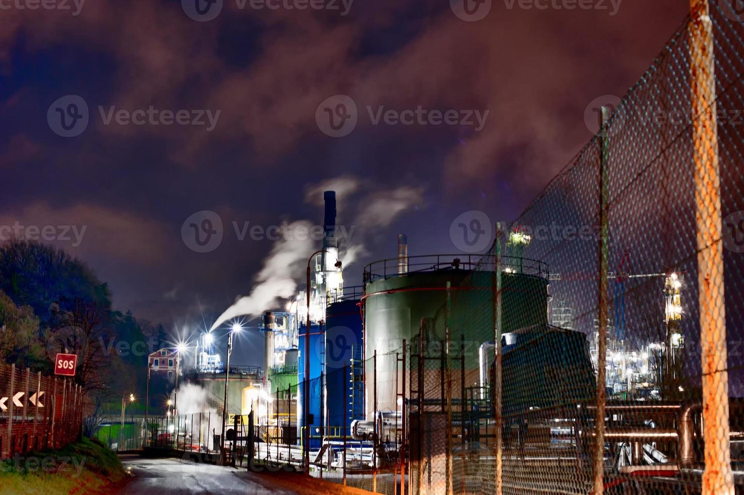 A petroleum oil refinery in a dramatic night painting scene nuclear apocalypse photo