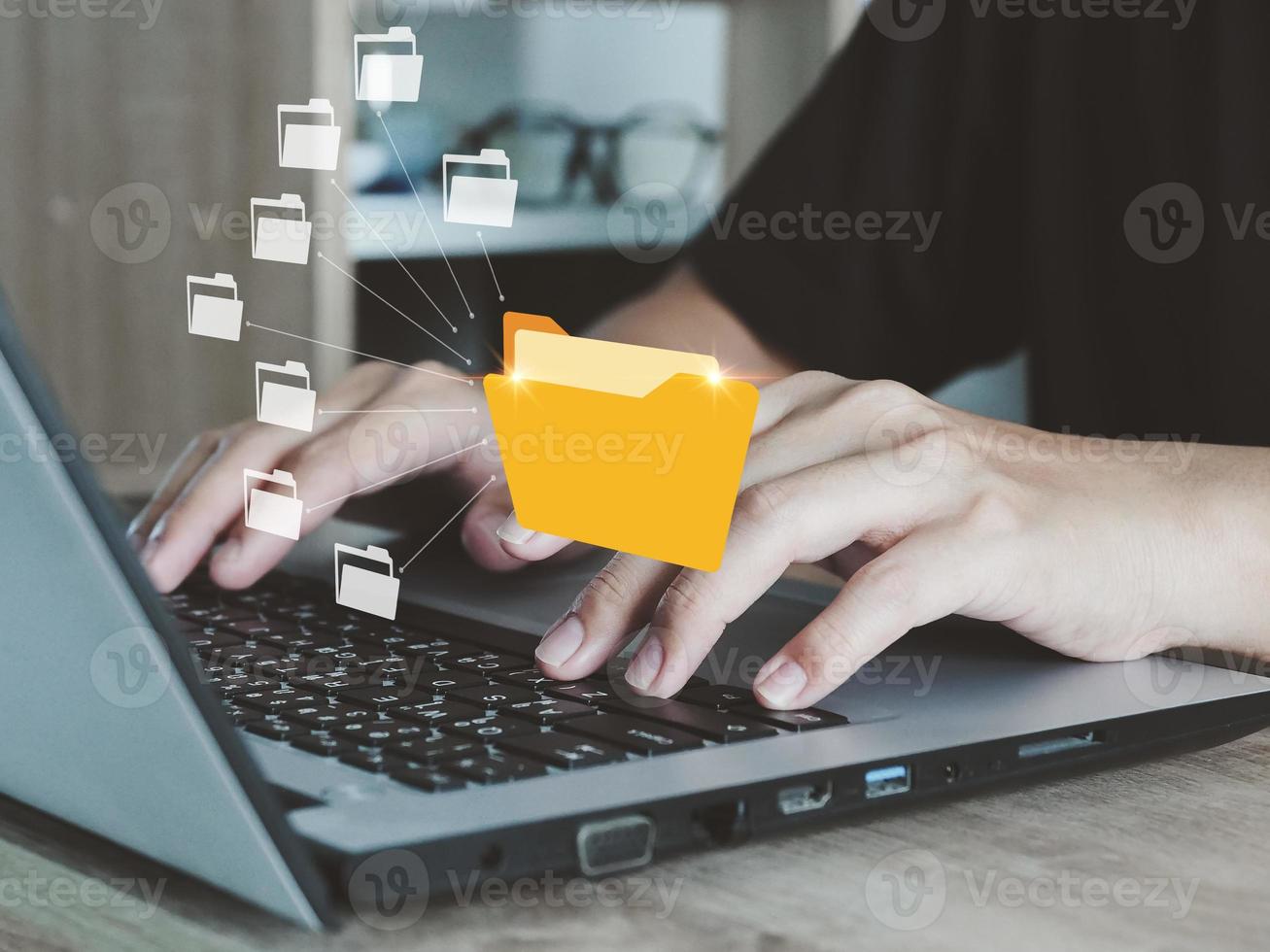 Businessman who is using a laptop to reach document folder with many document folders inside document management system access to desired files internal document search photo