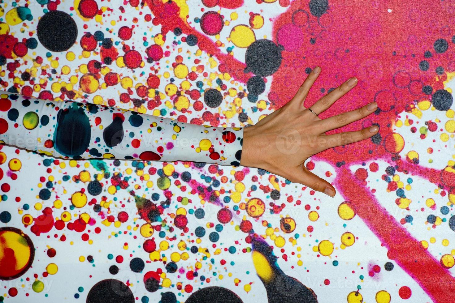 female hand on colour wall background texture photo
