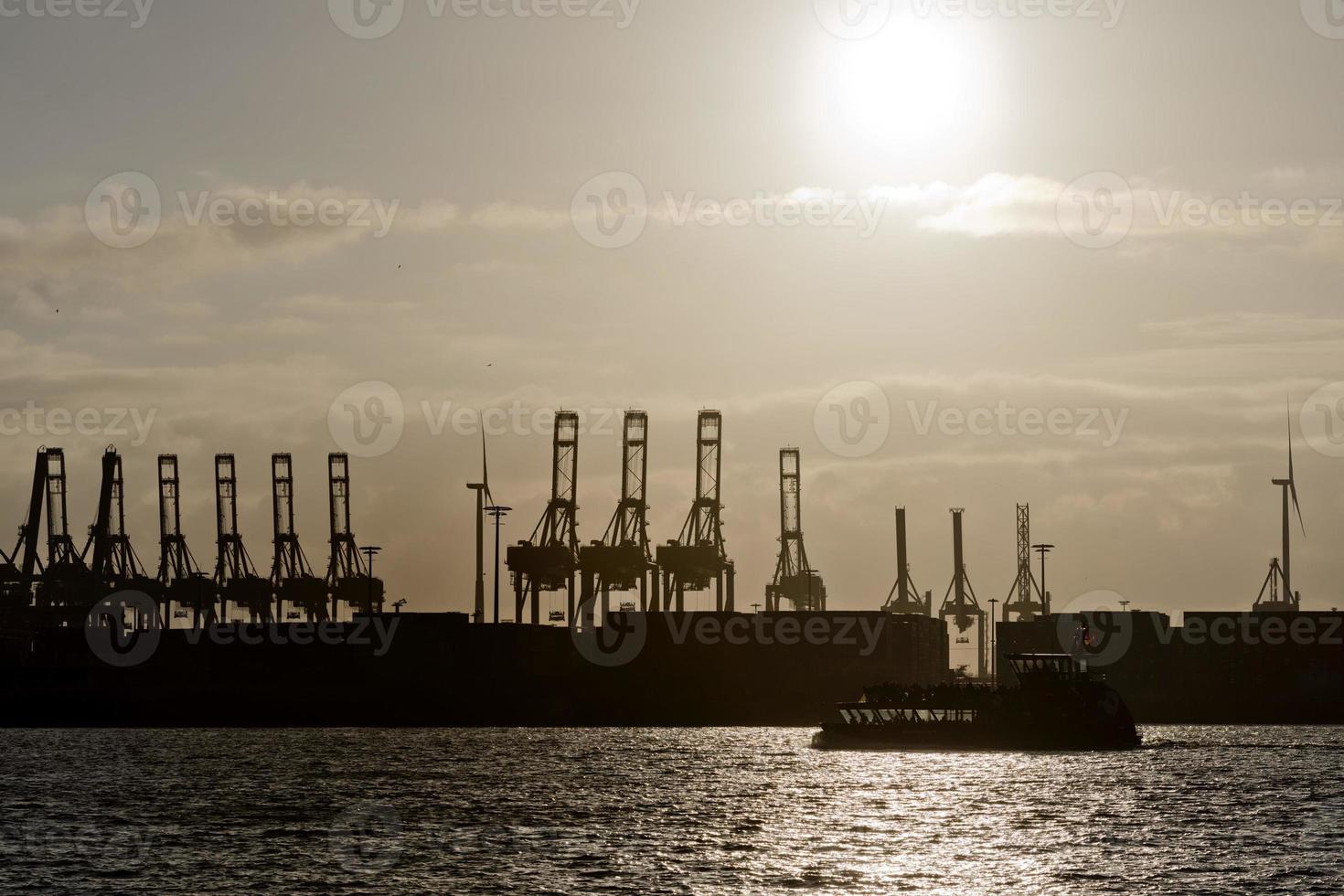 hamburg port crane silhouette at sunset photo