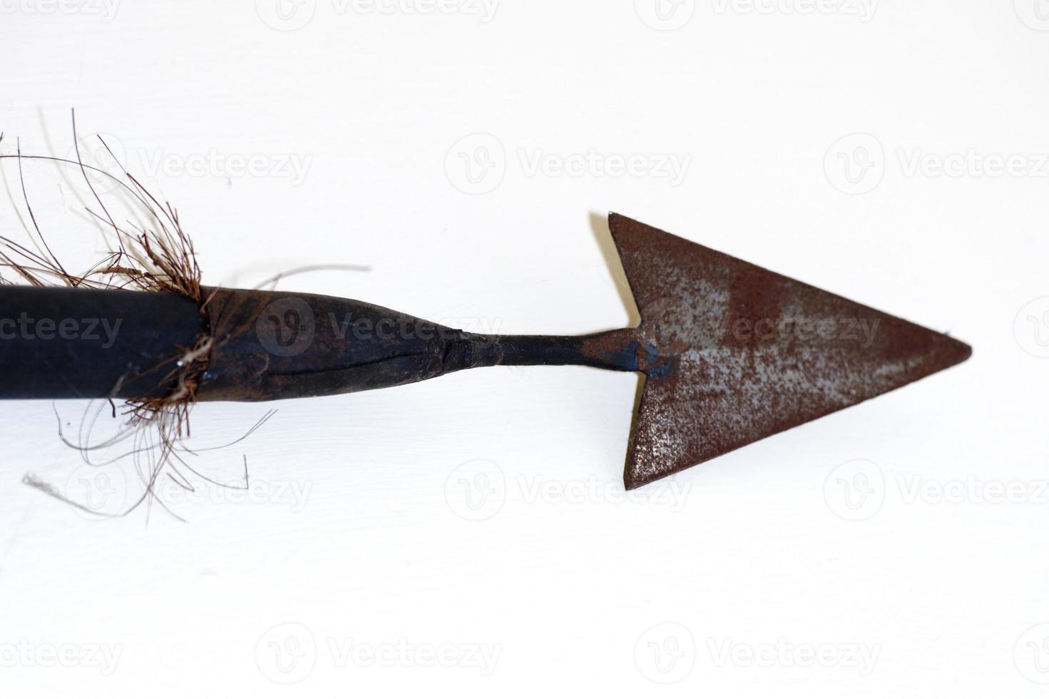 Vintage metallic spear head on white background photo