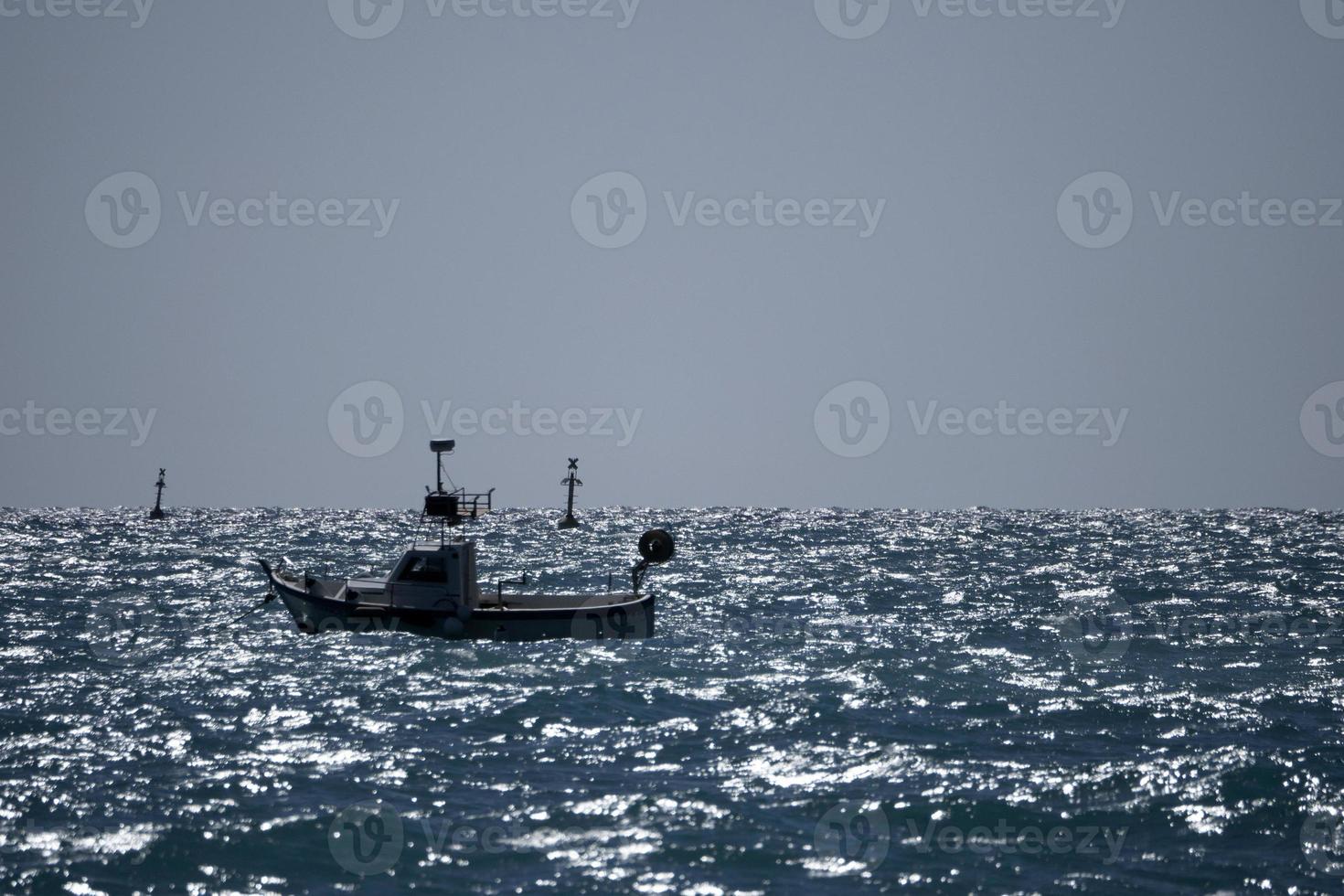 small boat in high waves sea photo