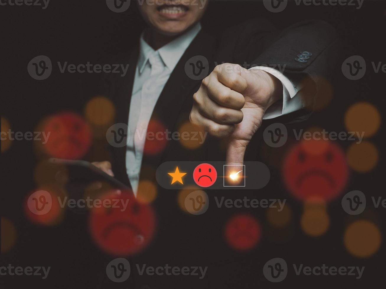 Businessman doing online surveys Dissatisfied survey rating lowest score Poor service quality, at 1 star, grumpy face photo