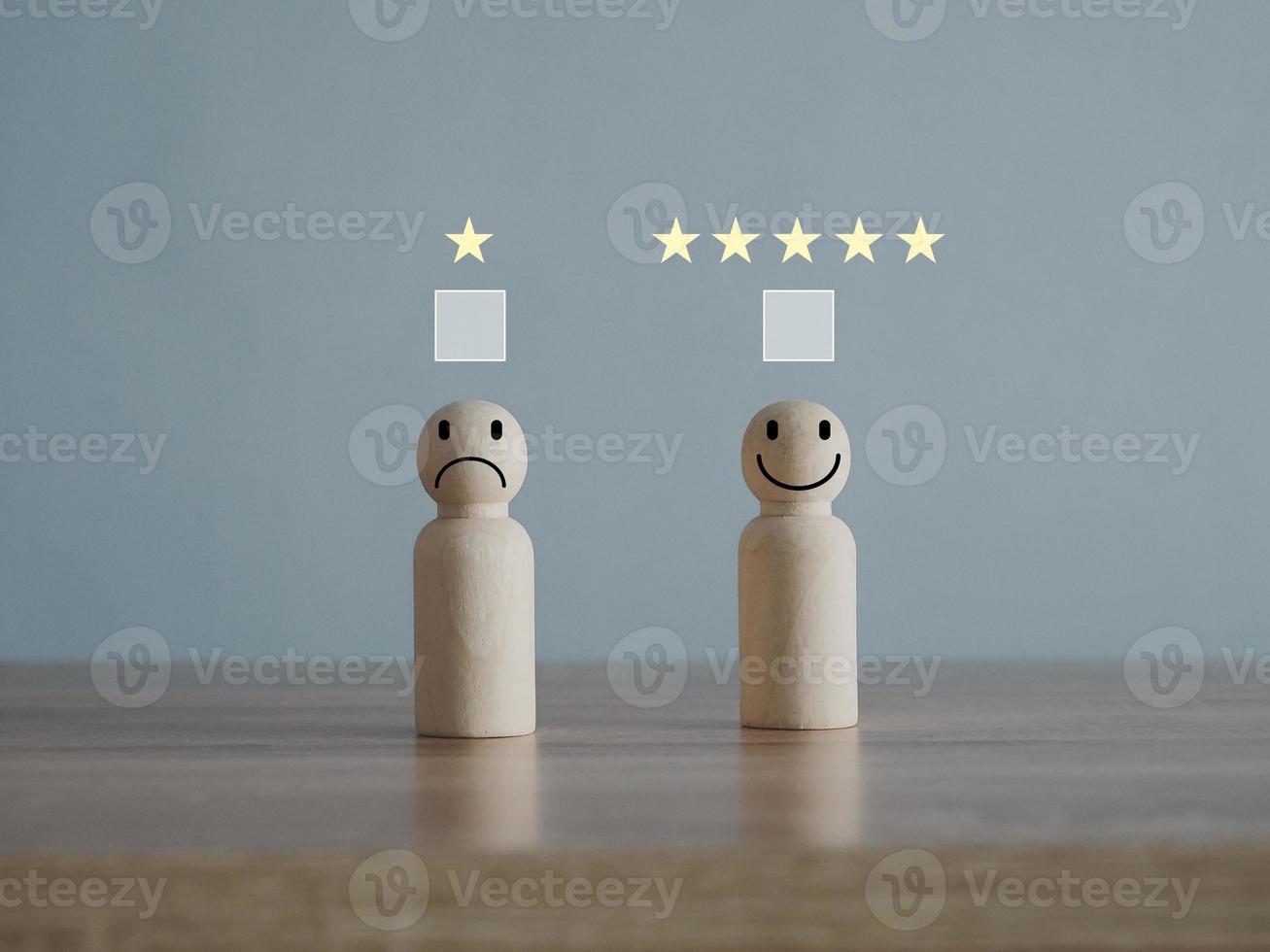 Wooden mannequins with smiling and frowning faces on a wooden table. Rating. Choosing service satisfaction. photo