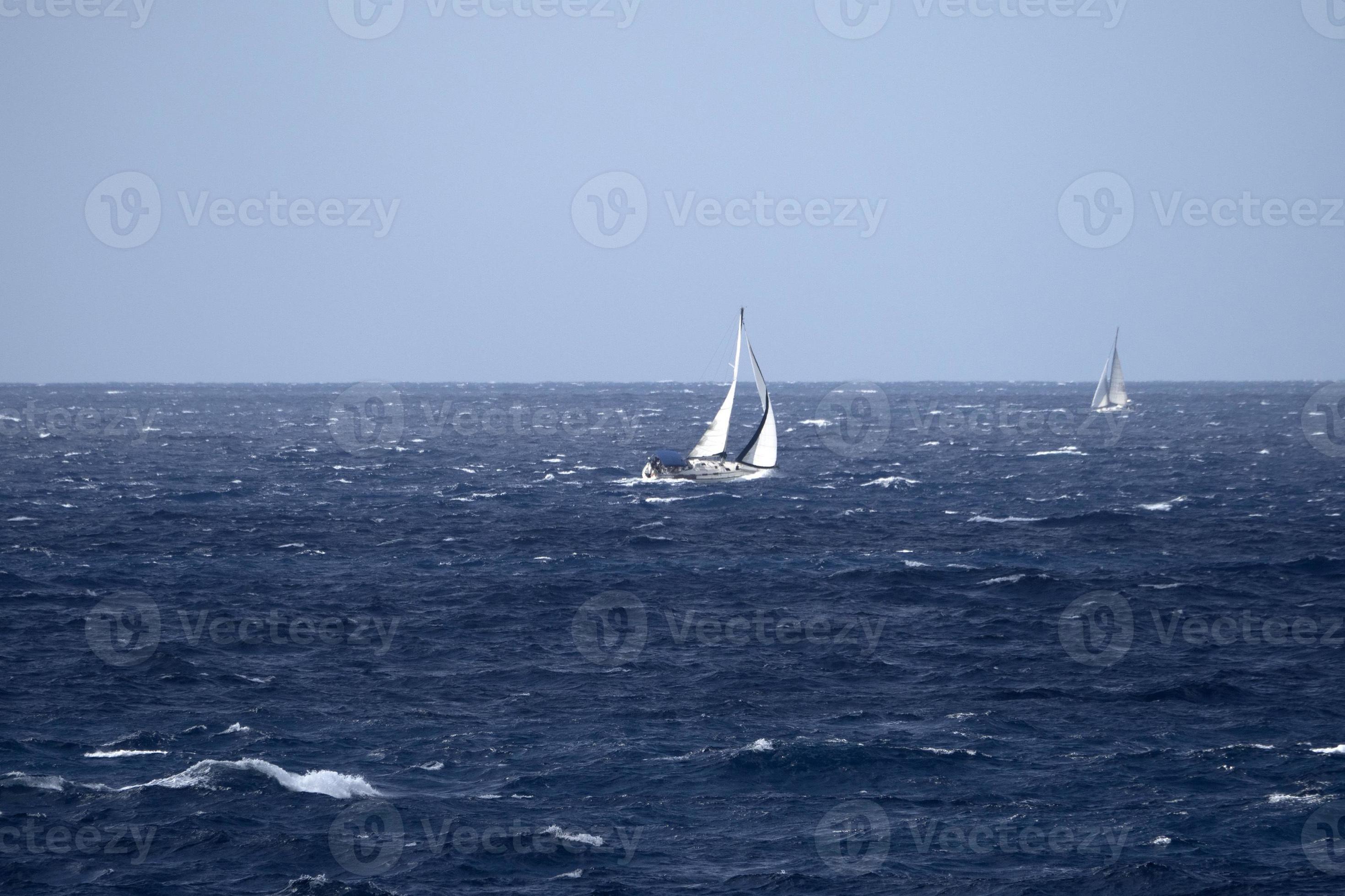 sail boat in high waves sea 20179167 Stock Photo at Vecteezy