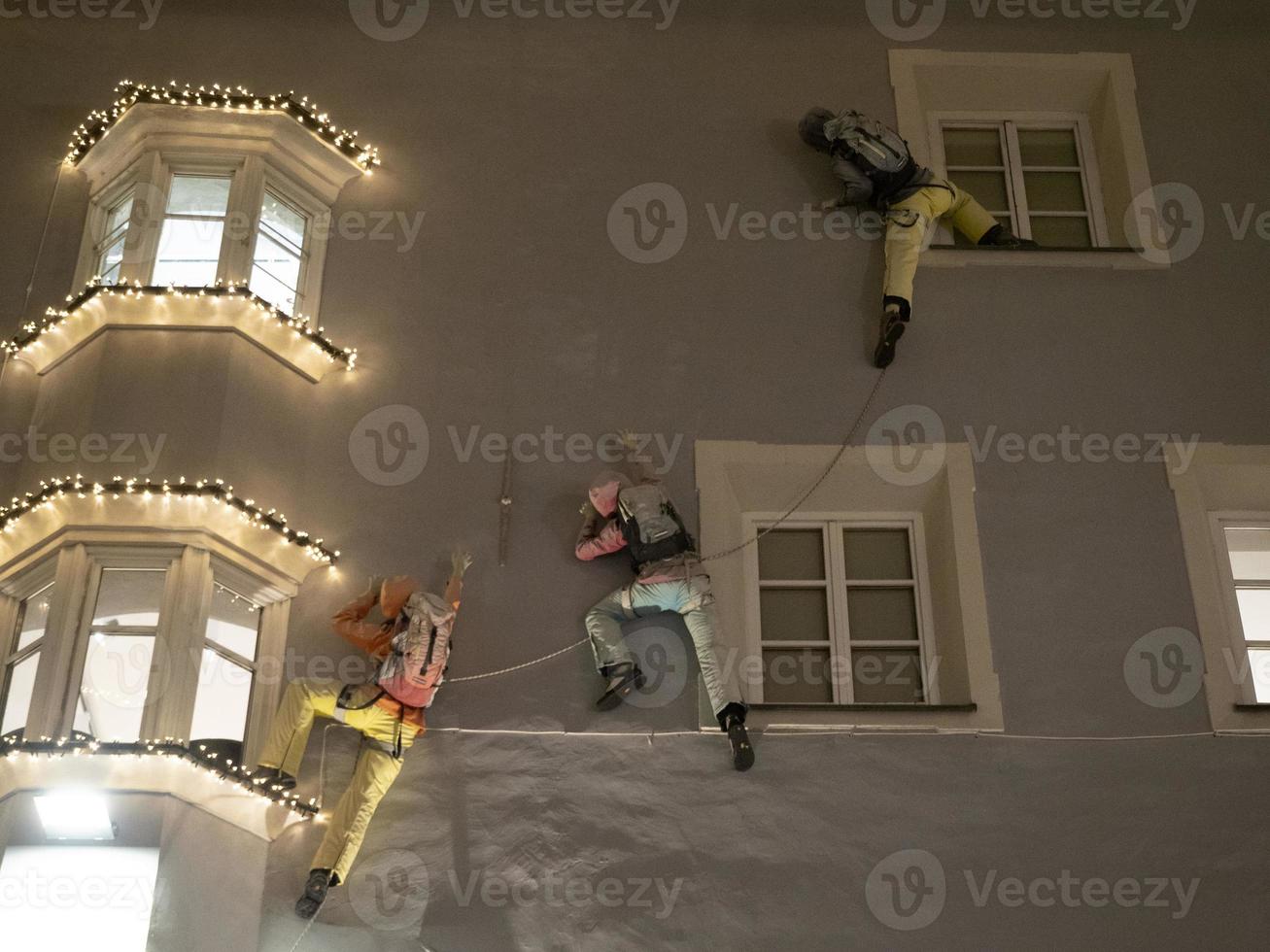 climber on a building climbing at night photo