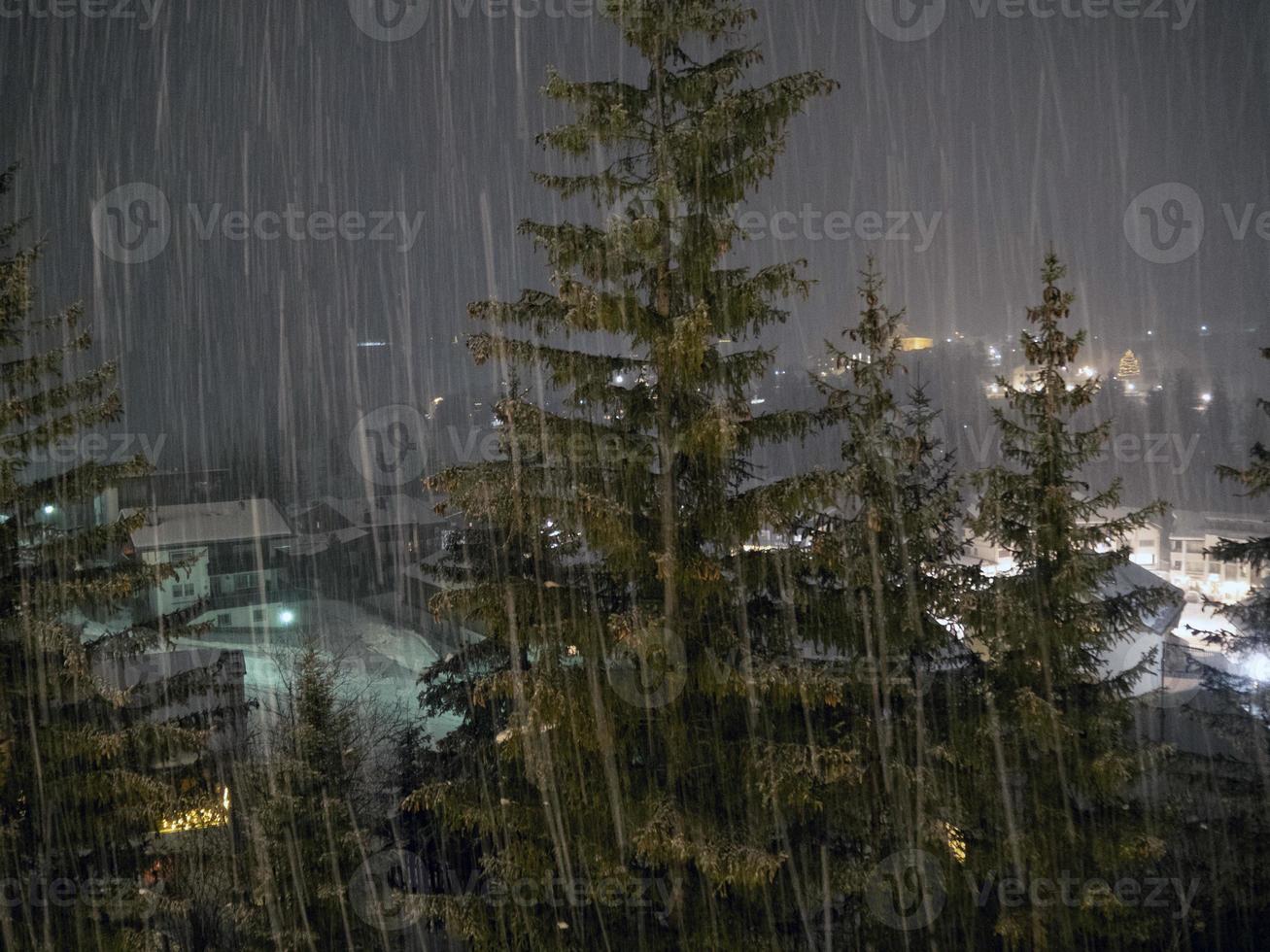snowing at night in dolomites mountains photo