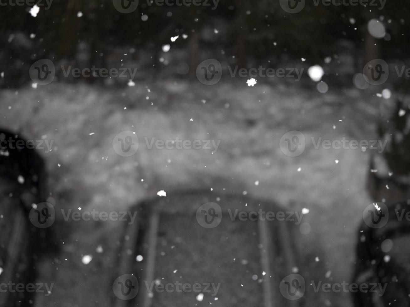 snowing at night in dolomites mountains car park photo