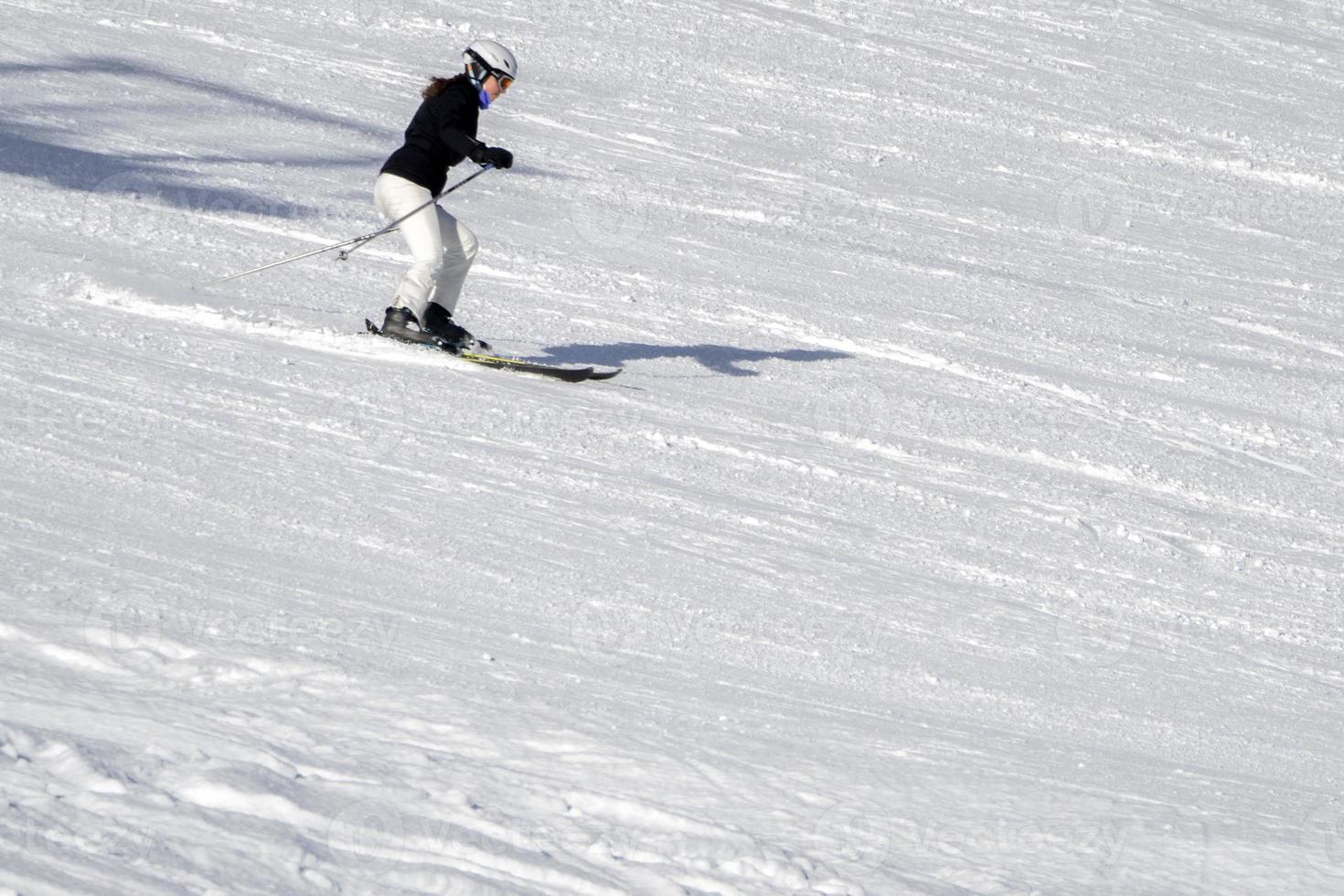 skier skiing with good style in dolomites snow mountains photo