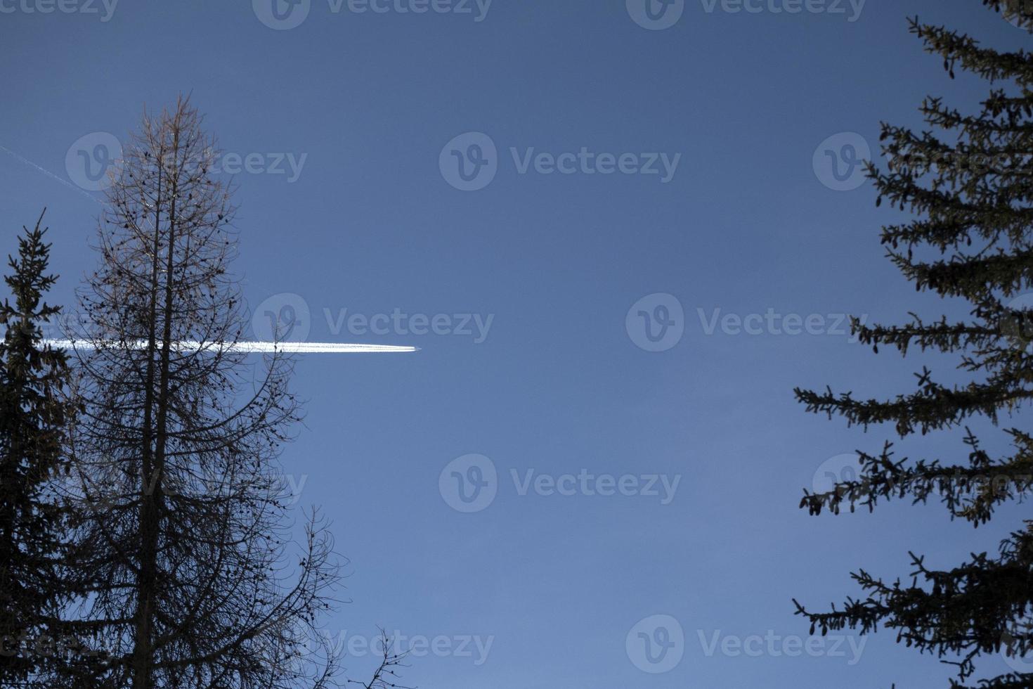 airplaine wakes on blue mountain dolomites sky photo