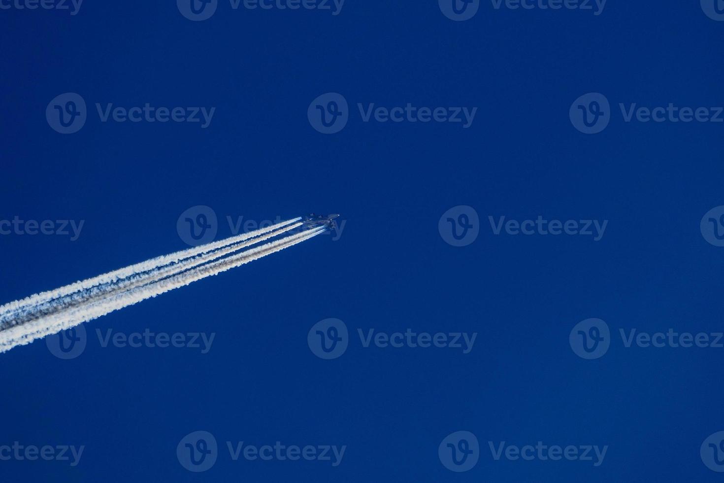 jet airplaine wakes on blue sky photo