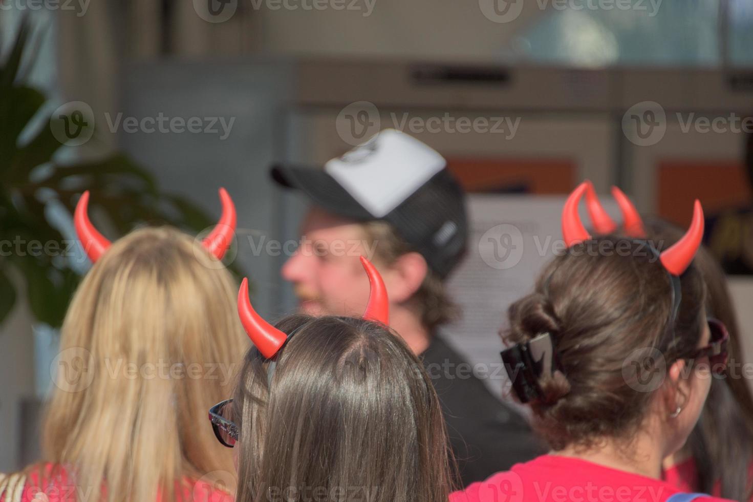 Red devil horns girl from the back photo