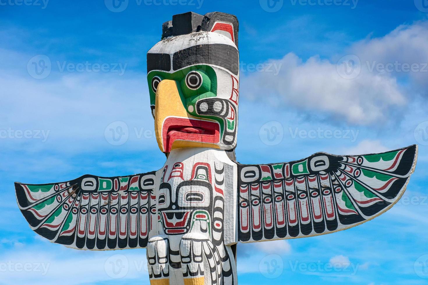 Totem wood pole in sky background photo