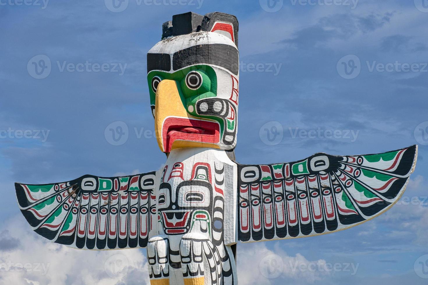 Totem wood pole in sky background photo