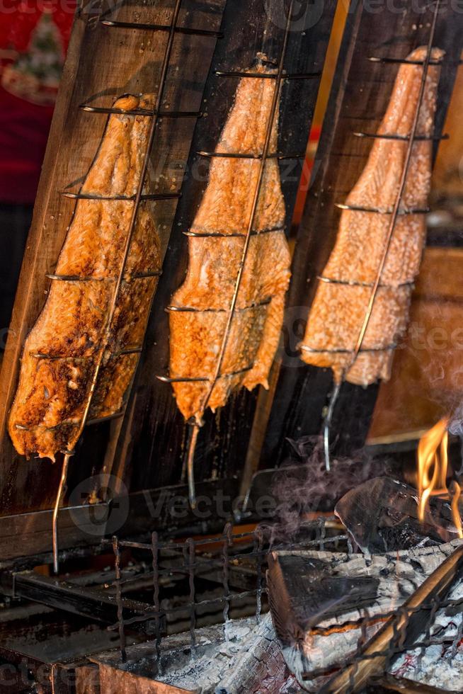 Salmon on smoking stand with natural wood smoke photo