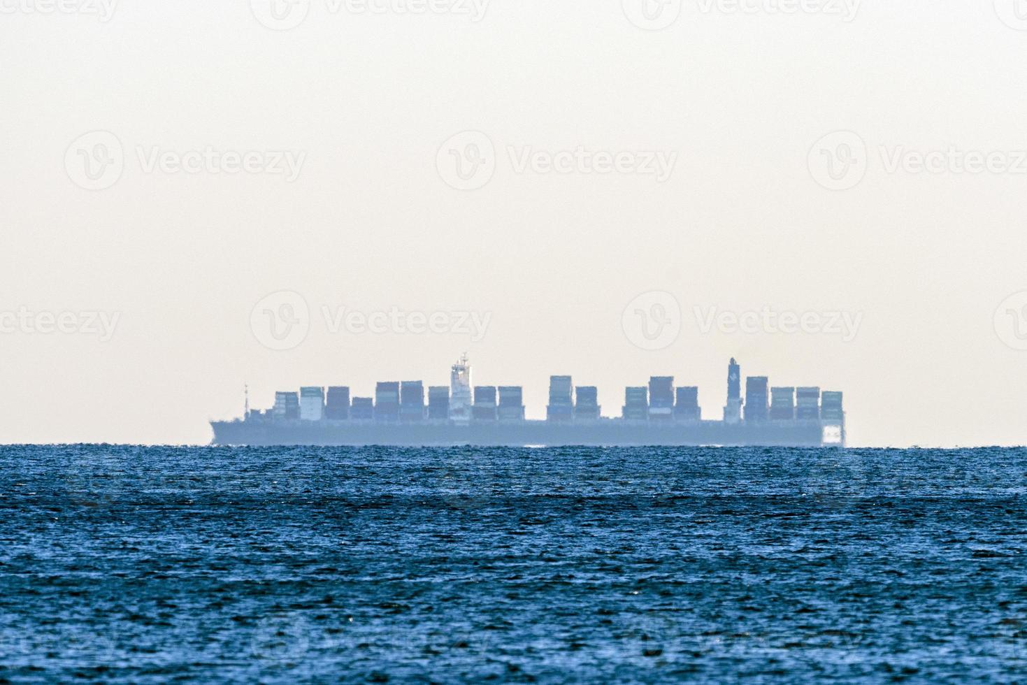Big ship mirage on sea horizon line photo