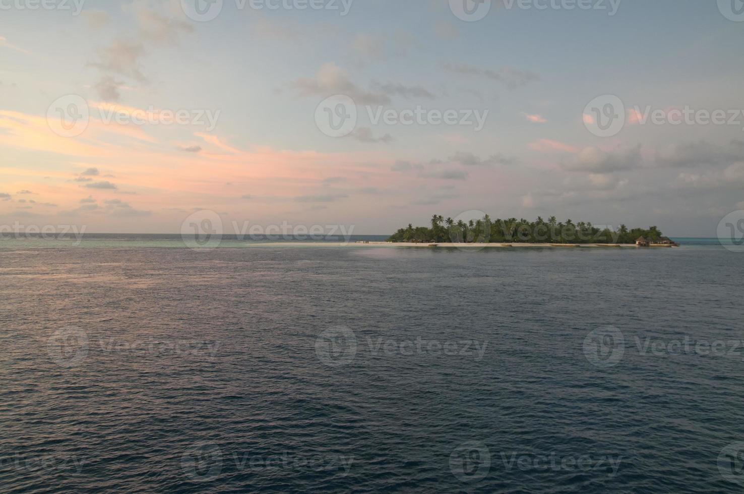 A colorful sunset in the middle of indian ocean in Maldives photo