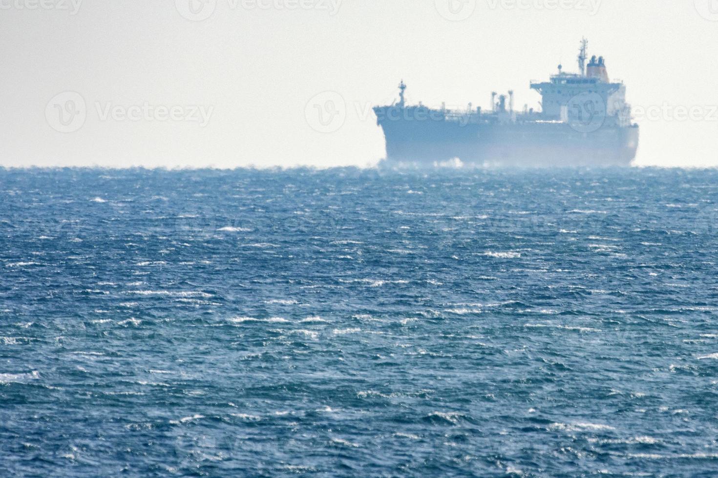 Big ship mirage on sea horizon line photo