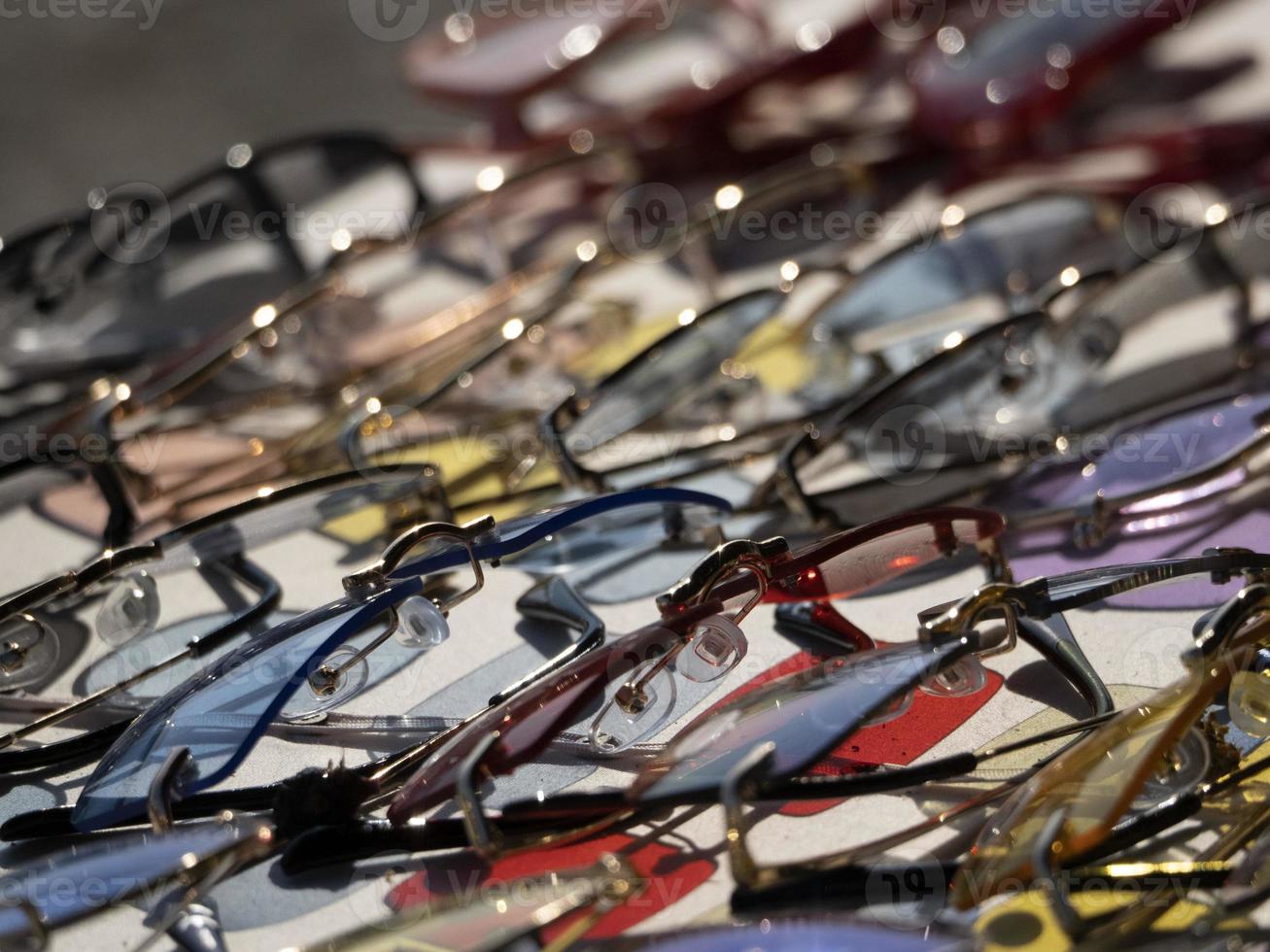 Many sunglasses for sale at street market photo