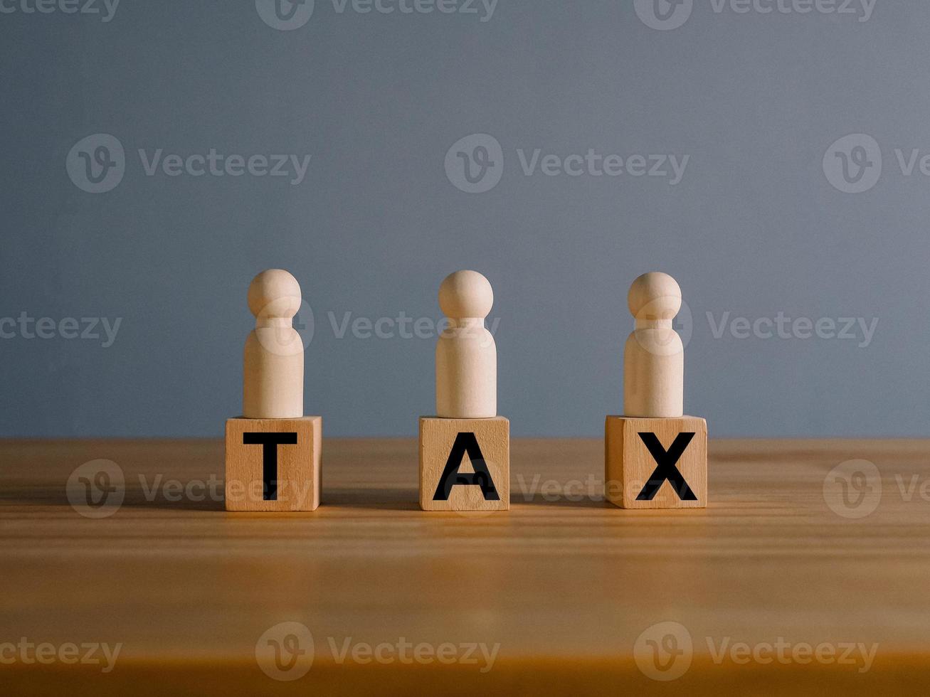 Tax concept with rising wooden blocks Expenses that are running higher than income photo