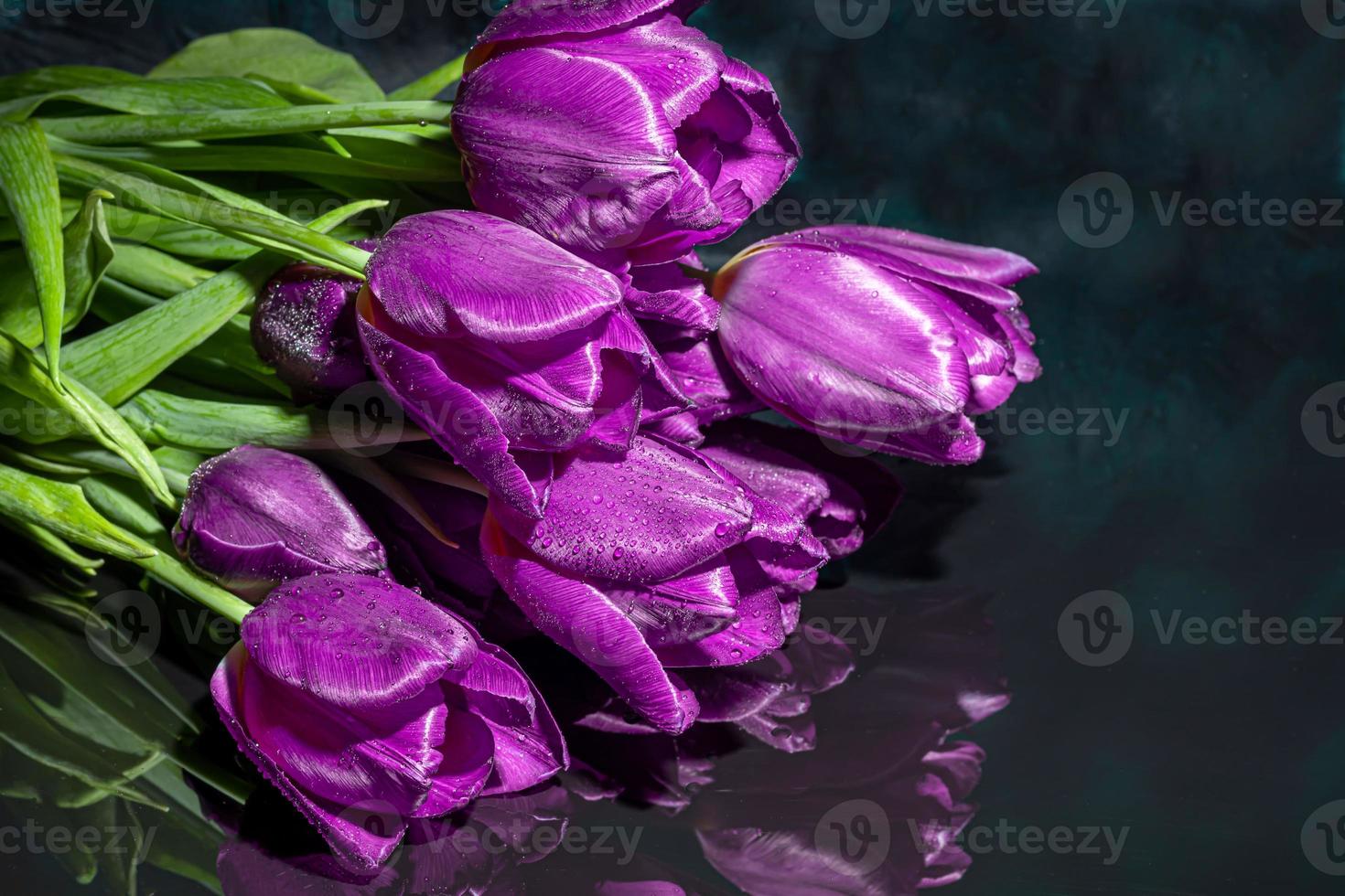 Bouquet of tulips for the holiday. Women's day, Valentine's day, name day. On a dark background with reflection. photo