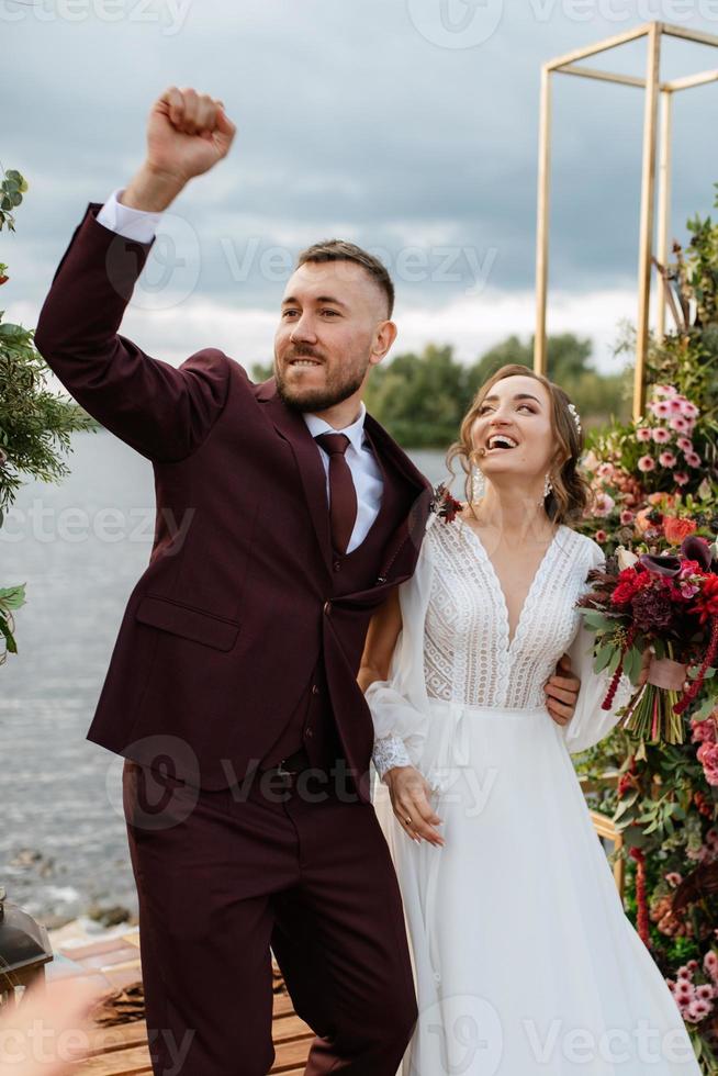 wedding ceremony of the newlyweds on the pier photo