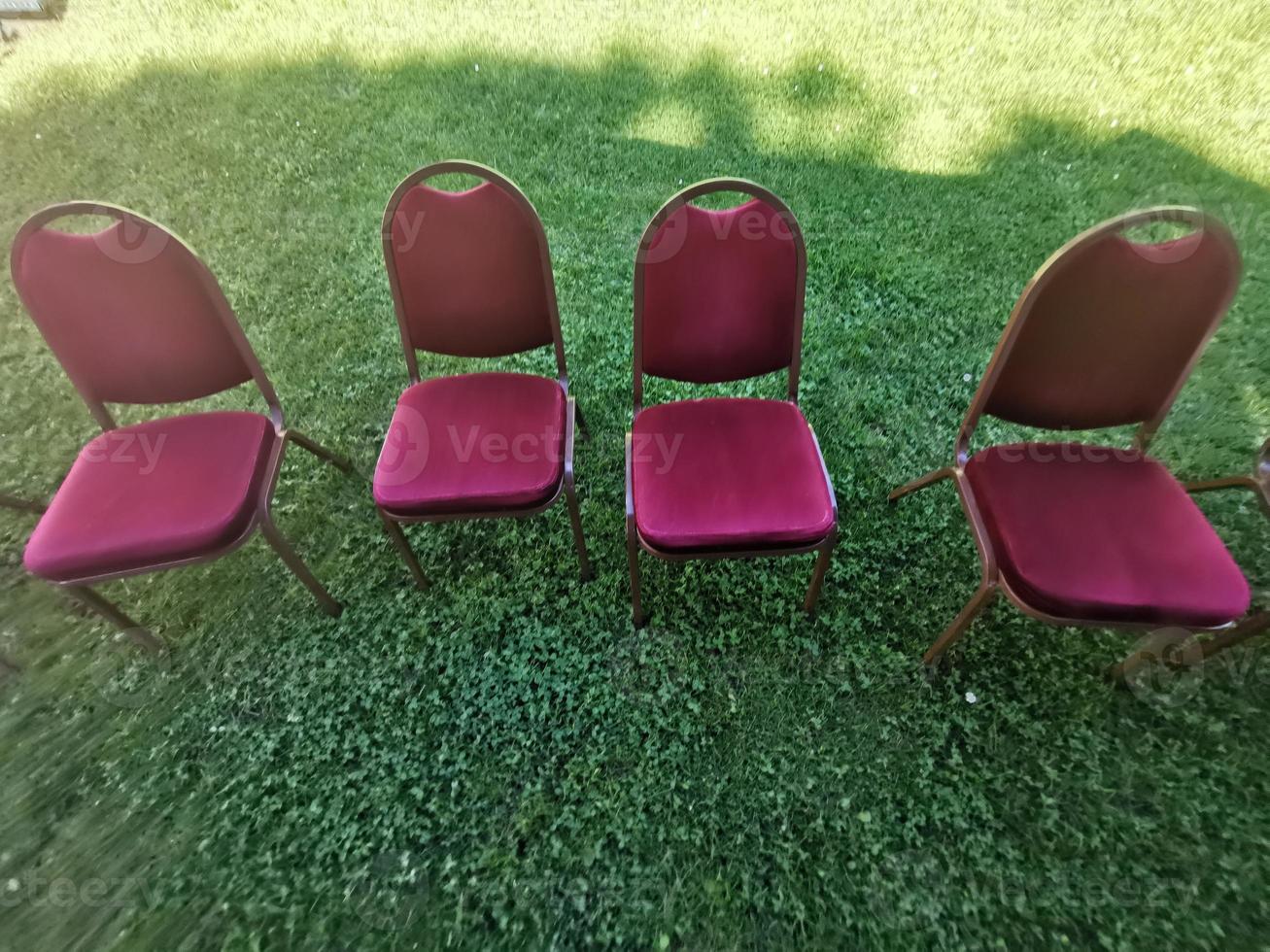Many red chairs on the grass photo