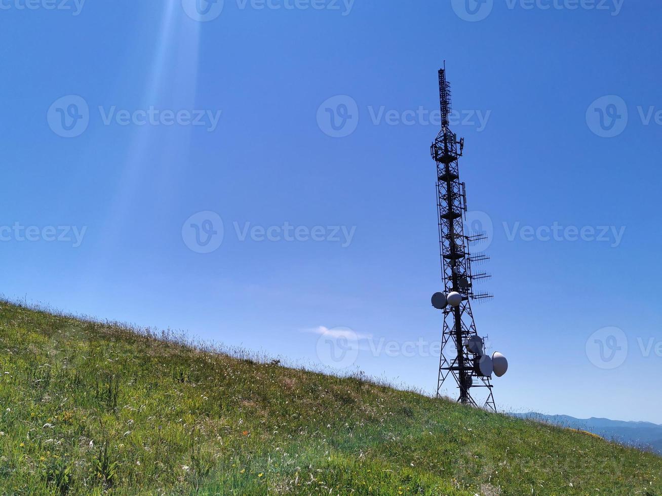 telecom cellular Communication Antenna tower on blue background photo