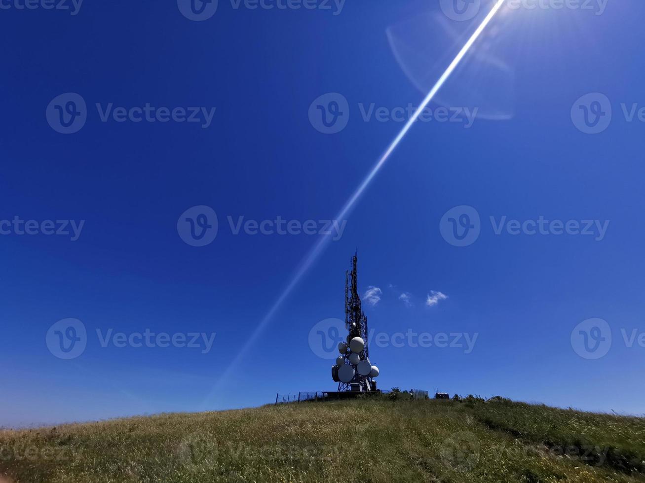 telecom cellular Communication Antenna tower on blue background photo