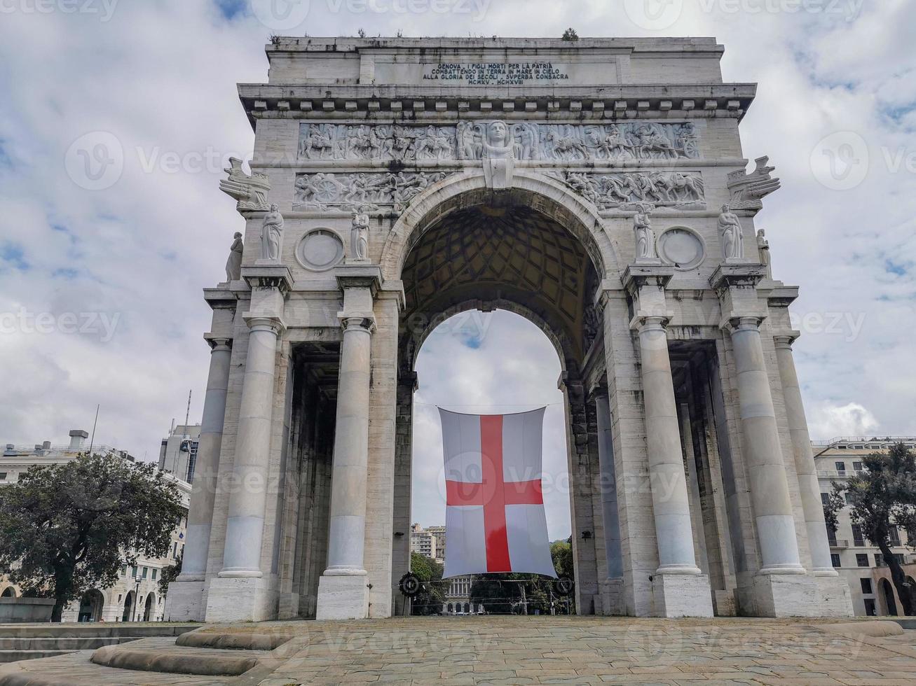 triumph arc in genoa with flag red cross in white photo