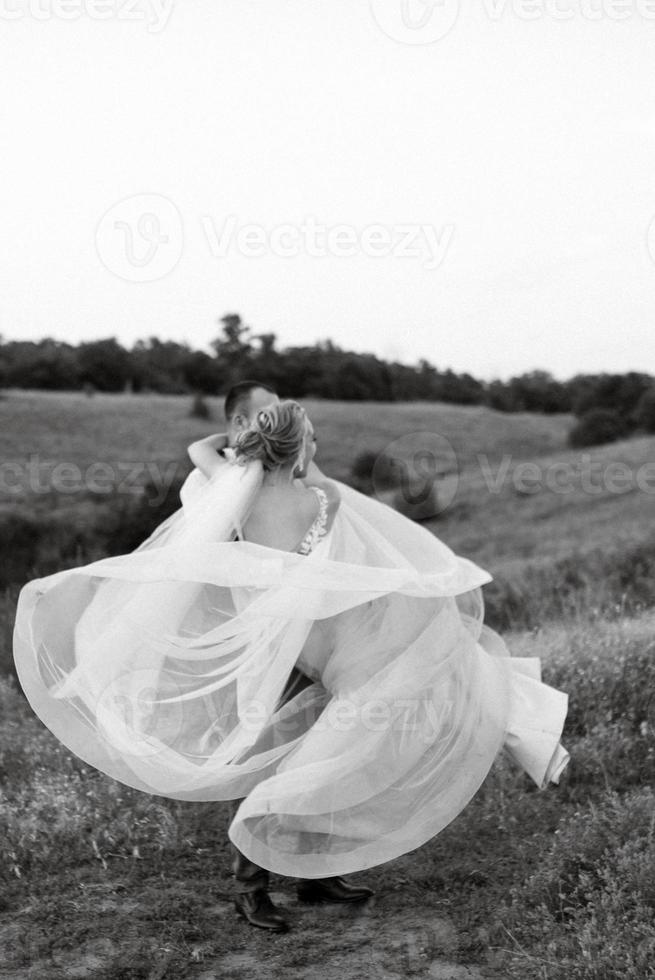 bride blonde girl and groom in a field photo