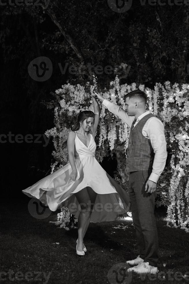 couple of newlyweds on the evening illuminated arch photo