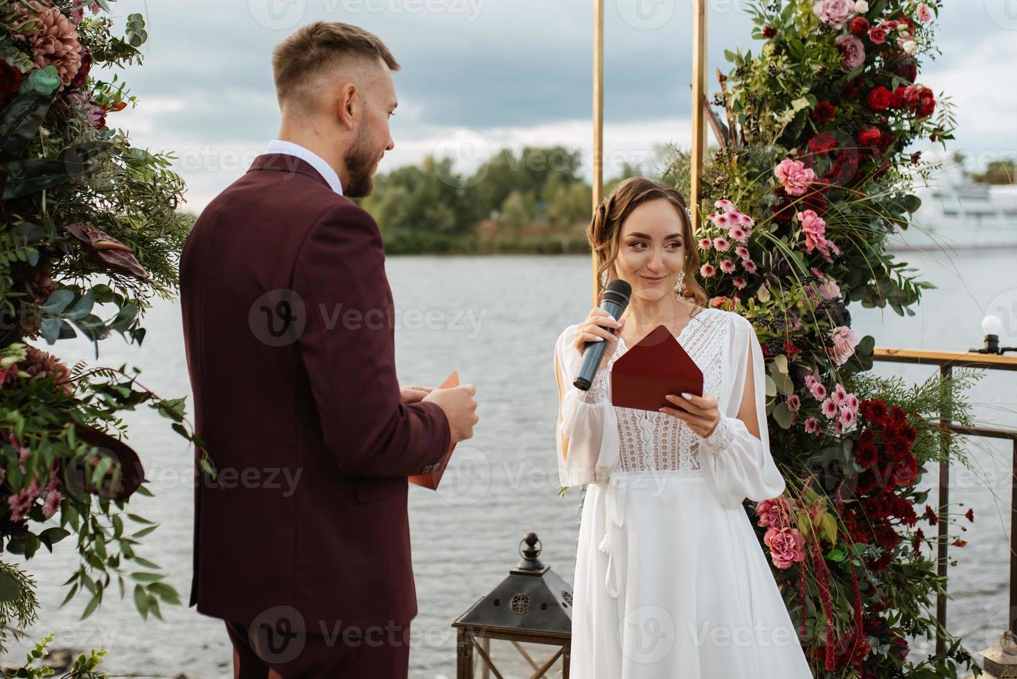 wedding ceremony of the newlyweds on the pier photo