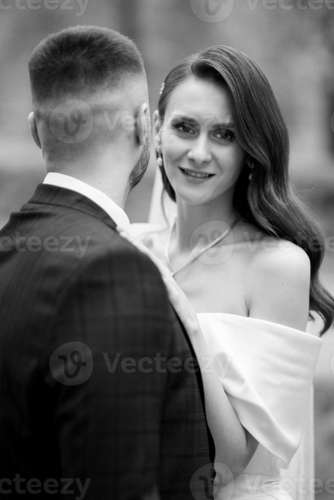 newlyweds walk in the park among cherry blossoms photo