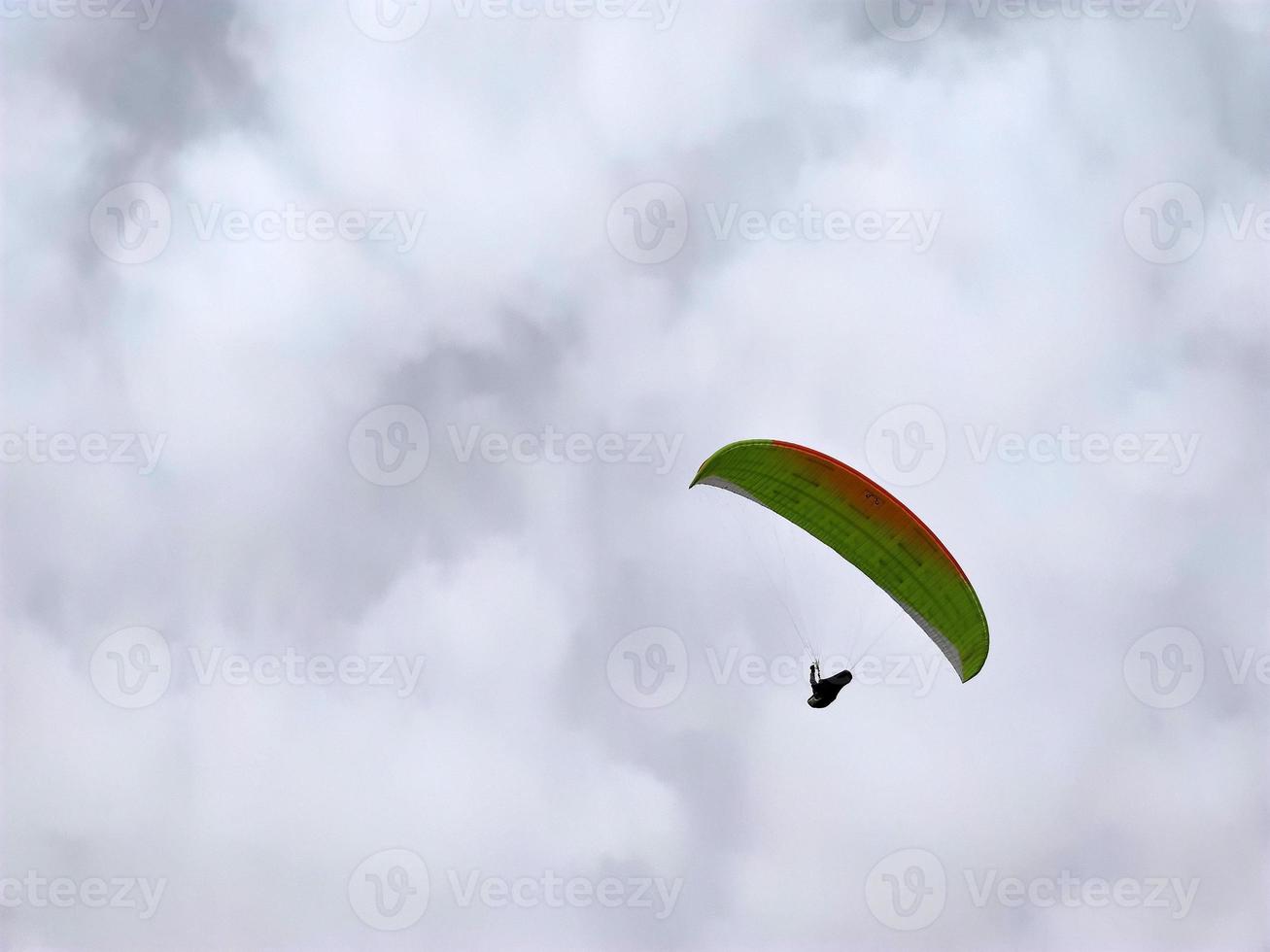 paraglider on cloudy sky photo