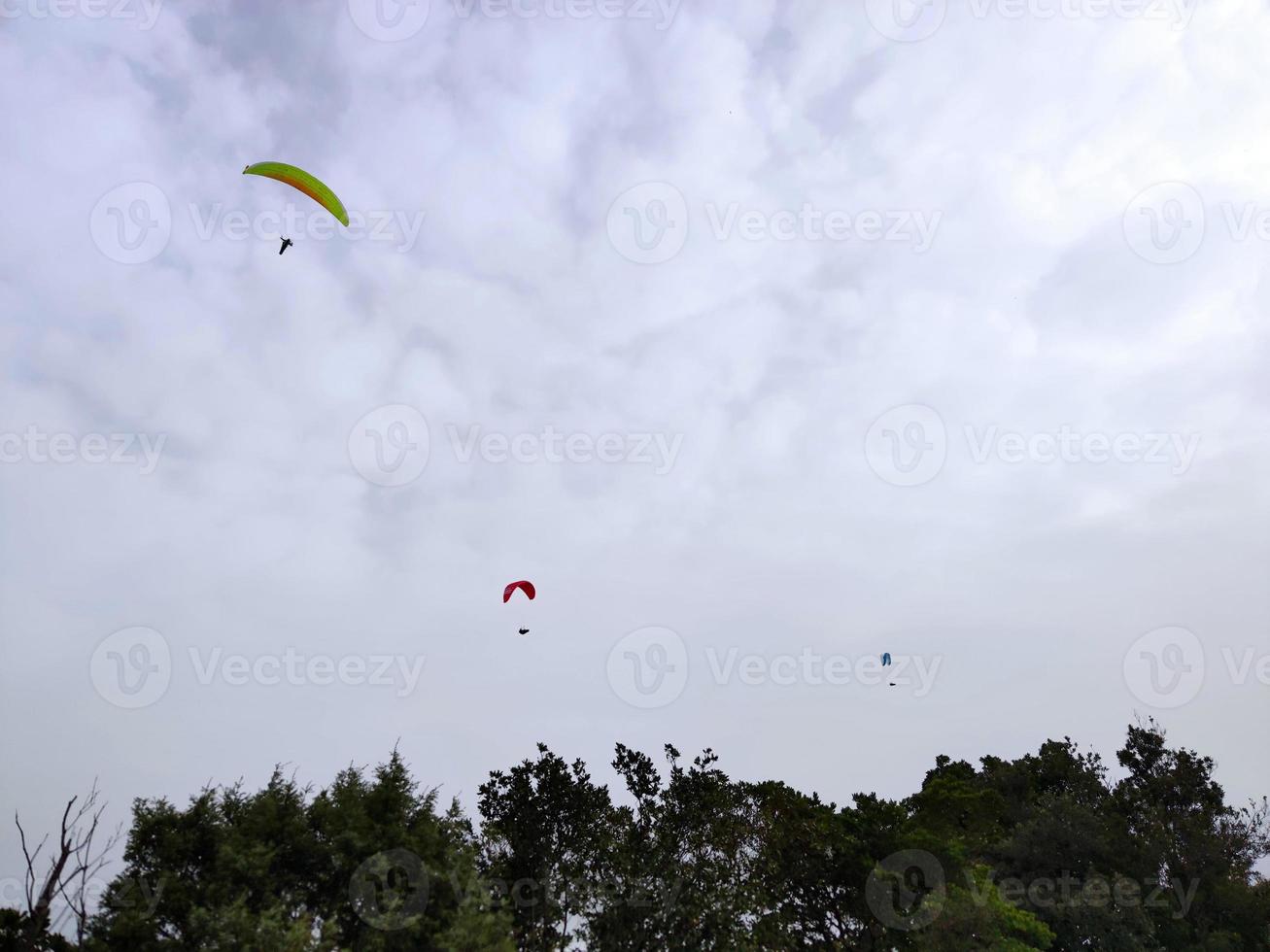 paraglider on cloudy sky in monterosso cinque terre italy photo