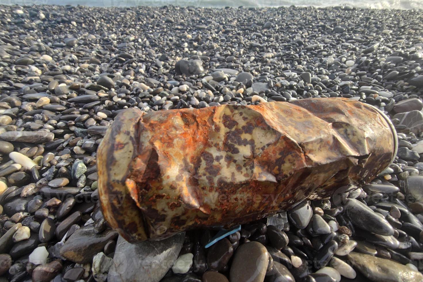 rusted can on the beach photo