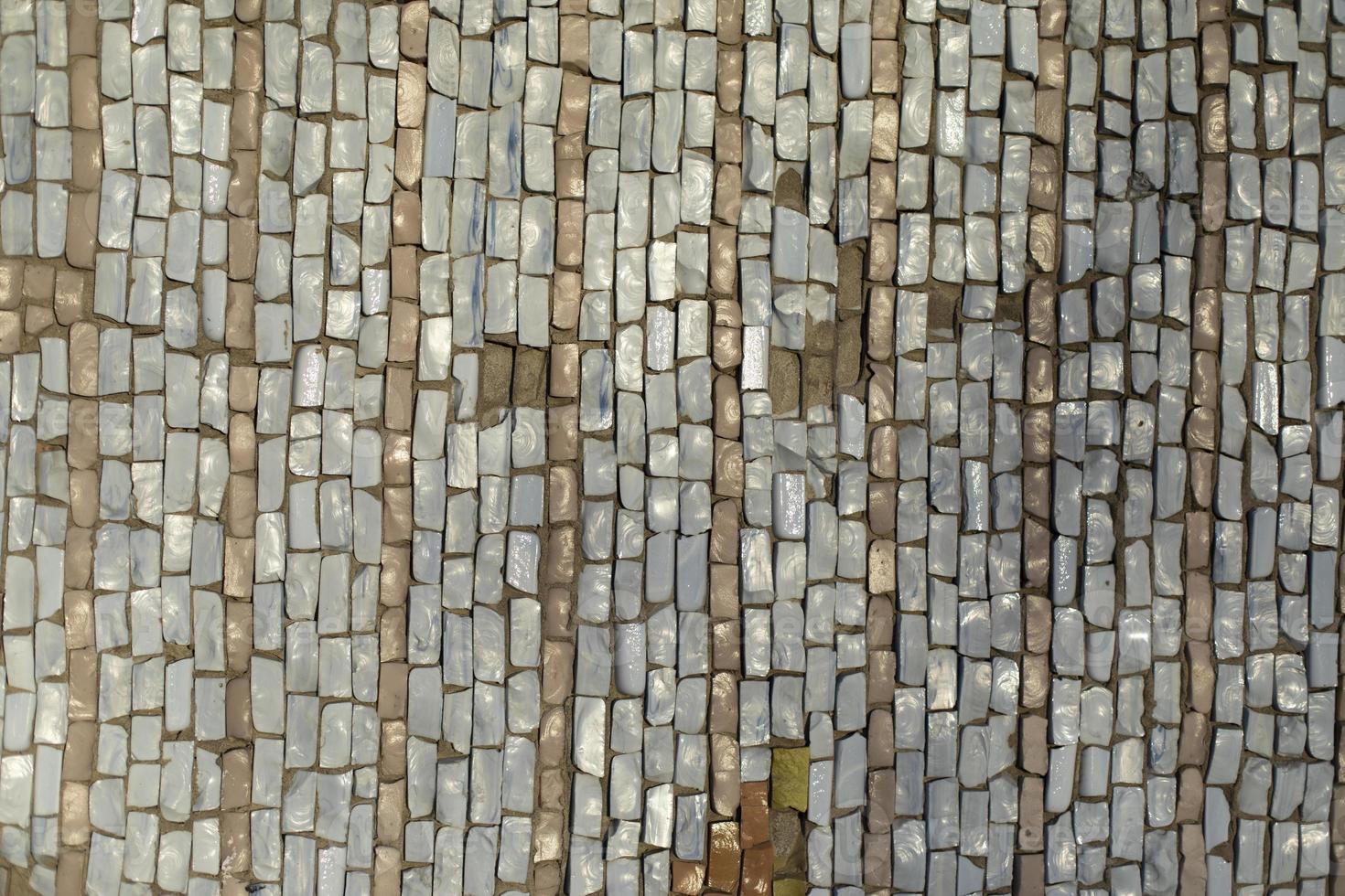 Tiles on wall. Mosaic tile. Pattern of shards of colored stone. photo