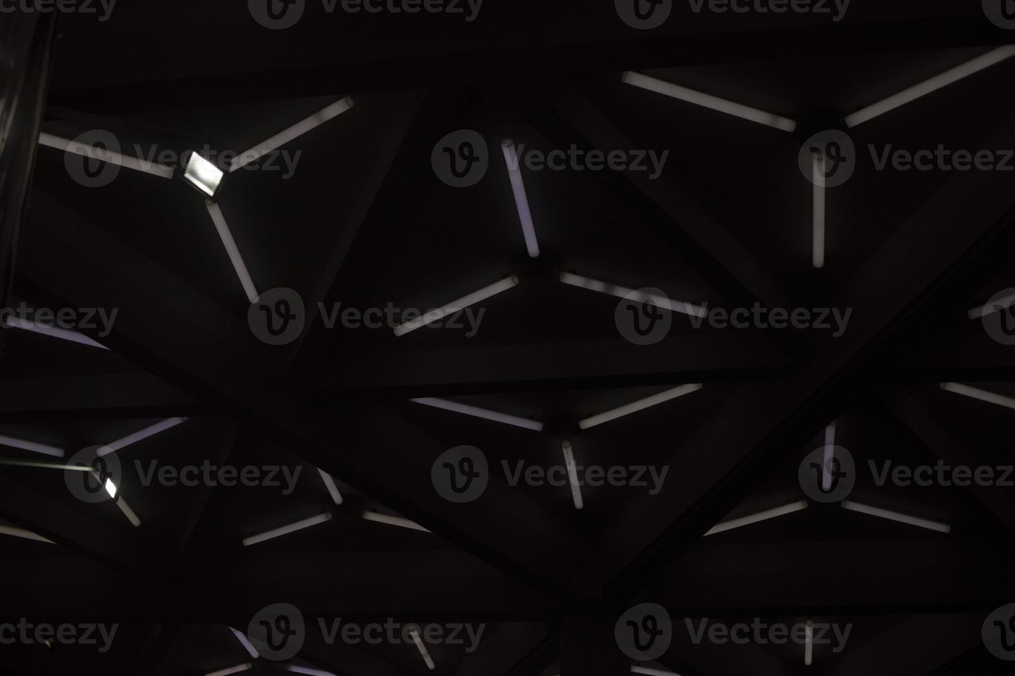 Triangular lamps on ceiling. Modern architecture. Light design. photo