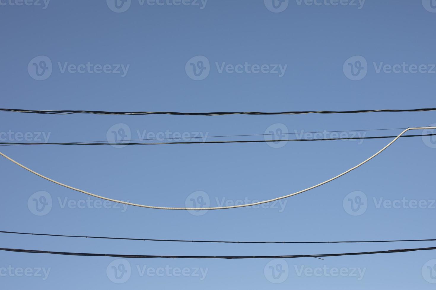 Wire on sky background. Electrical wires hanging. Communication links. photo