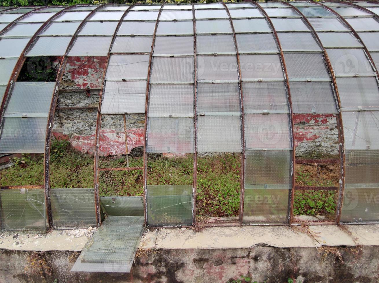 old abandoned greenhouse broken windows photo