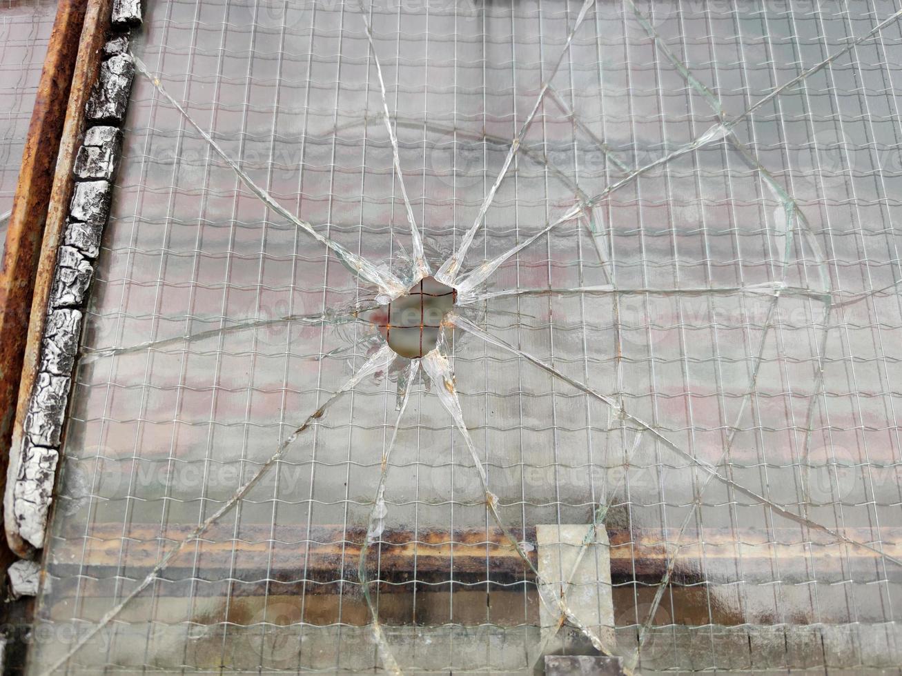 gun bullet broken window glass photo