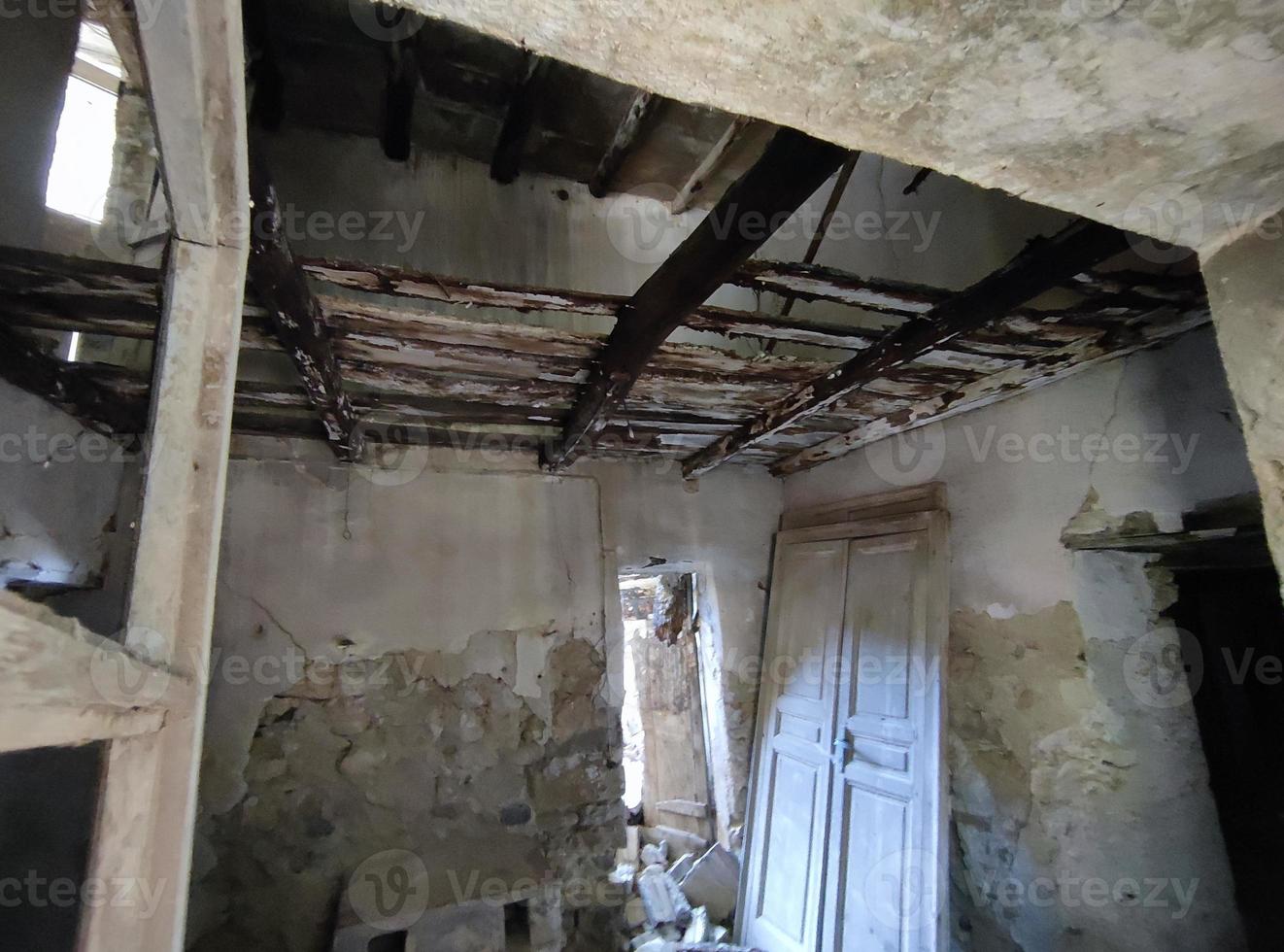 old abandoned roof collapsed farm house building in italy photo