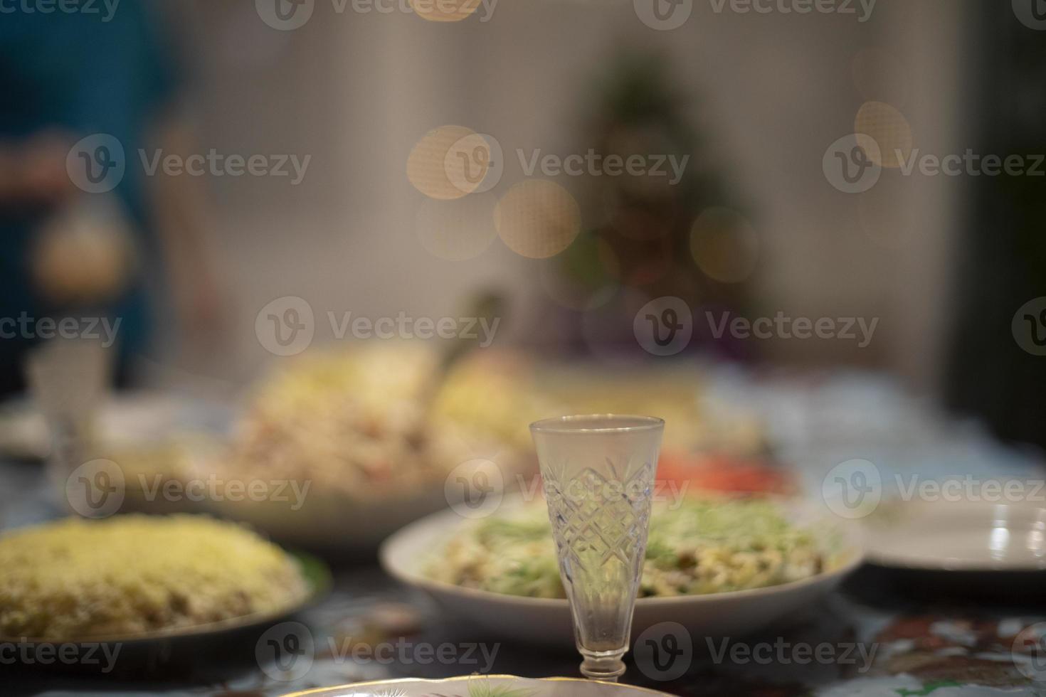 Glass of vodka on table. Festive table. Glass for alcoholic beverage. photo