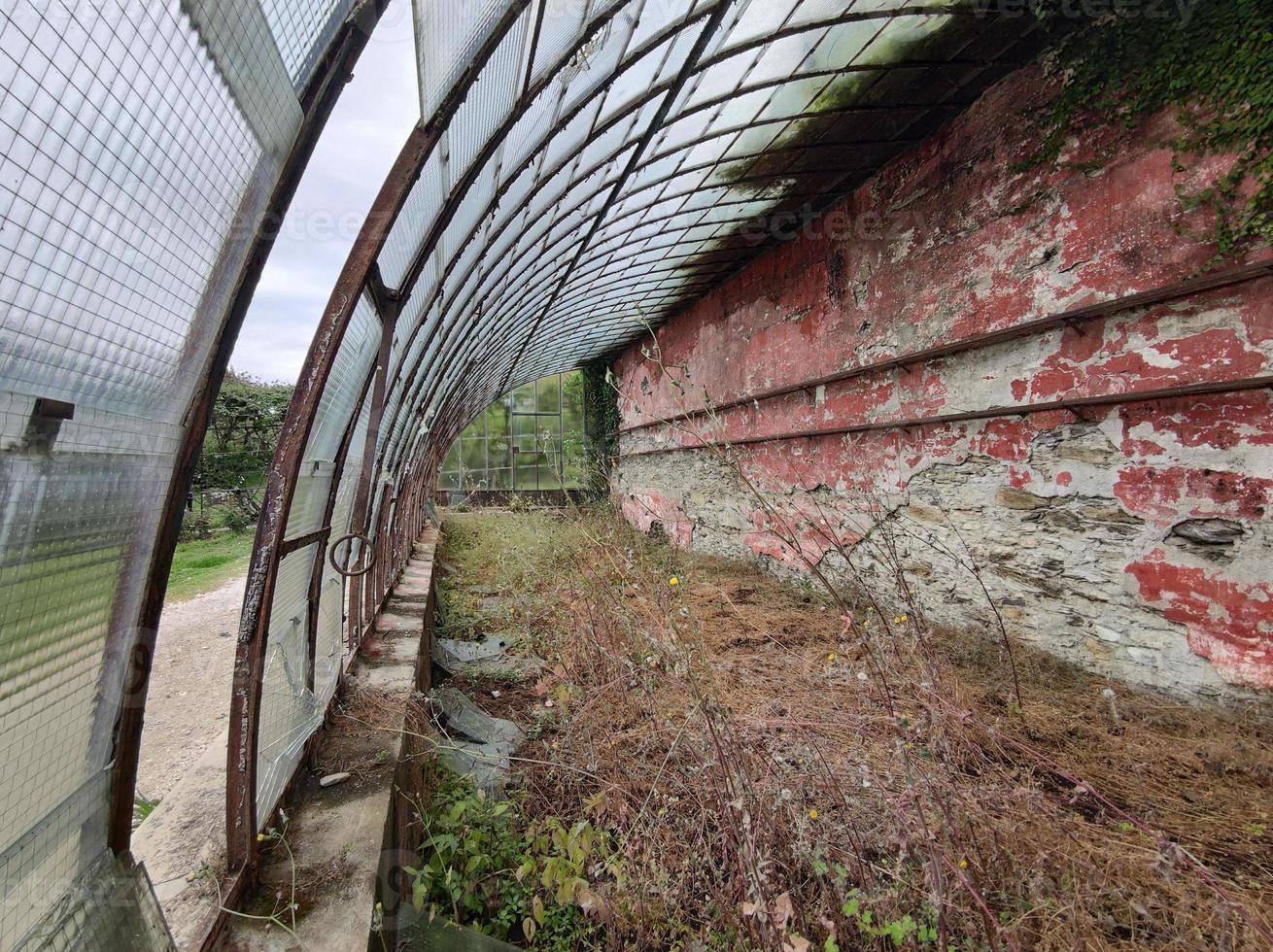 old abandoned greenhouse broken windows photo