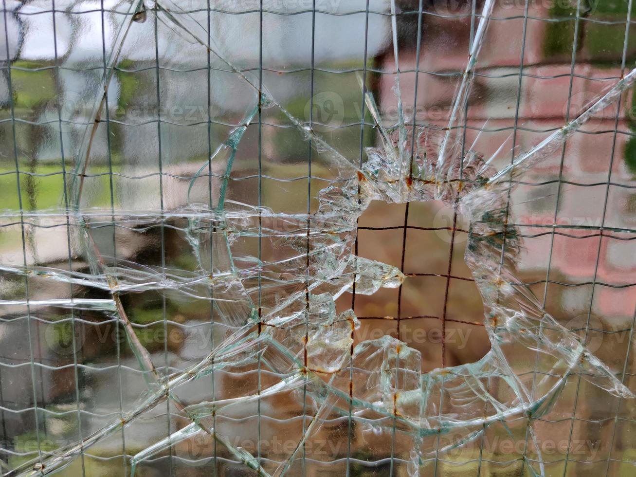 gun bullet broken window glass photo
